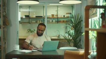 African American man wearing casual clothes working in his home video