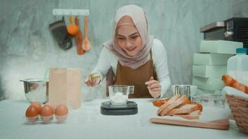 Young beautiful muslim woman is baking in her kitchen , bakery and coffee shop business video