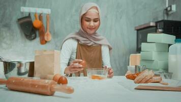 Young beautiful muslim woman is baking in her kitchen , bakery and coffee shop business video