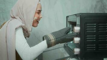 Young beautiful muslim woman is baking in her kitchen , bakery and coffee shop business video