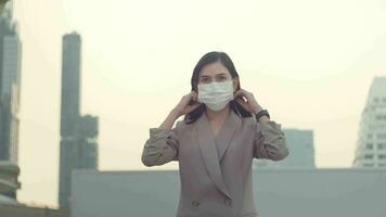 A portrait of Businesswoman is taking face mask off in modern City , people lifestyle , End of Covid-19 pandemic concept video