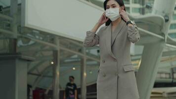 A portrait of Businesswoman is taking face mask off in modern City , people lifestyle , End of Covid-19 pandemic concept video