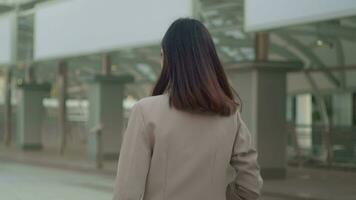 A young beautiful businesswoman is  walking in Modern city , city lifestyle concept video