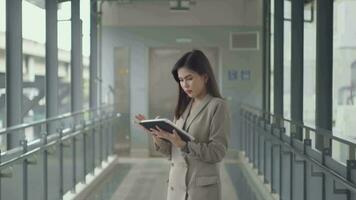 A young beautiful businesswoman is using tablet in Modern city , business technology , city lifestyle concept video