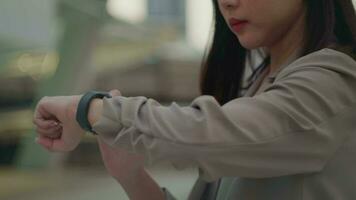 Businesswoman is using Smart watch in Modern city , business technology , city lifestyle concept video