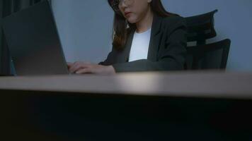 Stressed young business woman working on laptop with documents in modern office, workload concept video