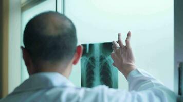 The doctor is analytic X-ray film , showing to patient , Health care concept video