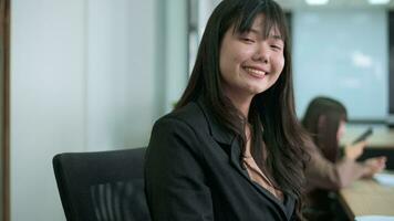 Portrait of Asian business woman is smiling in office video