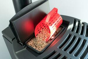 Modern domestic pellet stove, granules stove with 3d printed bucket photo