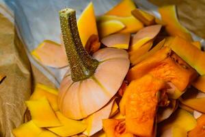 Freshly cut and peeled butternut, peelings for compost photo