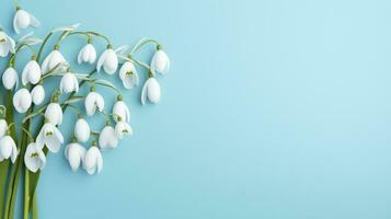 AI generated background on a pale blue background with snowdrop flowers photo