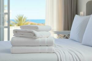 AI generated clean white towels on a hotel bed in a bright cozy room overlooking the sea photo