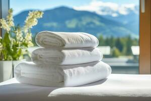 AI generated white towels on the bed in a hotel room, against the backdrop of a panoramic window overlooking the snow-capped mountains photo