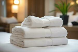 AI generated stack of neatly folded white towels on a bed in a hotel room photo