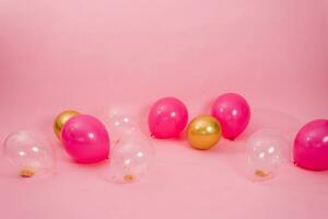 Group of multicolored transparent, pink and gold balloons lying on the floor in the house for Valentine's Day, Birthday, holiday concept photo