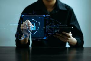 Cybersecurity and privacy concepts to protect data. Lock icon and network security technology. Man protecting personal data on smartphone tablet, virtual screen . In office photo