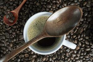 Coffee cup and beans on wooden table. Top view with copyspace. photo