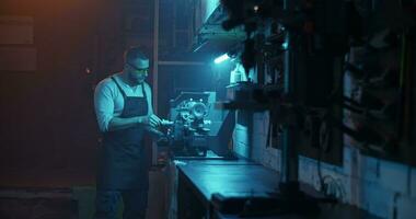 Male worker in eyewear using lathe machine video