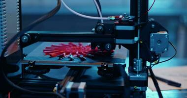 Modern 3D printer creating pink part in laboratory video