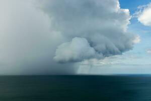 Clouds and rain are falling in the sea. photo