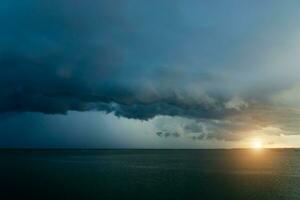 Dark Cloud rain are falling in the sea. photo