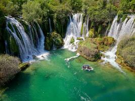 Aerial view of Kravica Waterfall in Bosnia and Herzegovina. The Kravica waterfall is a pearl of the Herzegovinian landscape. It is a unique natural beauty in the Trebizat River. Oasis in stone. photo