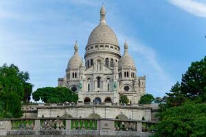 View of The Basilica of Sacre Coeur de Montmartre. One of the most visited religious monuments in Paris, France. photo