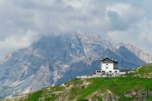 View of Rifugio Auronzo in the Dolomites, Italy. The mountain house is situated at an altitude of 2,333m on the South side of the massif of the Three Peaks and can easily be reached on foot or by car photo