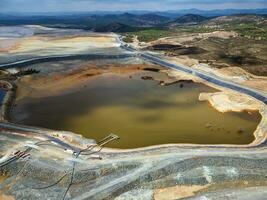 Aerial drone view of Mining activity. Apocalypse scenery. Earth destruction. Disruption of nature.  Extracting natural resources from the Earth to sell on the world market. Ecological disaster. photo