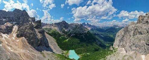 Panorama view of the blue turquoise Lake Sorapis, Lago di Sorapiss, with mountains with the background in Dolomites. One of the most beautiful lakes in Italy. Famous destination. photo