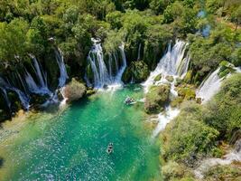 Aerial view of Kravica Waterfall in Bosnia and Herzegovina. The Kravica waterfall is a pearl of the Herzegovinian landscape. It is a unique natural beauty in the Trebizat River. Oasis in stone. photo