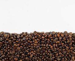 Arabica coffee beans roasted fragrant ready to make coffee that people like to drink placed on the white background looks beautiful photo