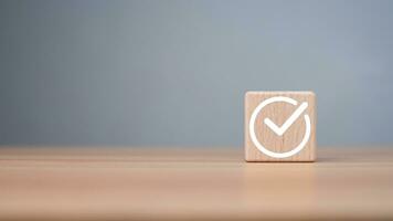 Checklist concept, Check mark on wooden blocks wooden background with copy space, project feasibility concept. Tick and cross signs. Checkmark and cross icons. approve and disapprove symbols. photo