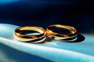 AI generated close up of two gold wedding rings on blue background bokeh style background with Generated AI photo