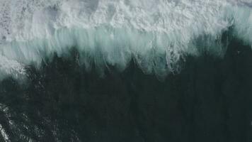 golven in de oceaan top visie. de zee water is schuimend. video