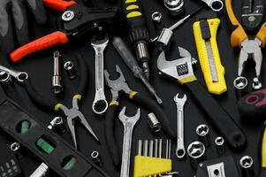 Many different tools for repair work on a black background. photo