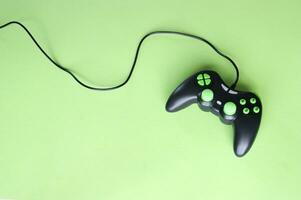 Joystick gaming controller isolated on green background. photo