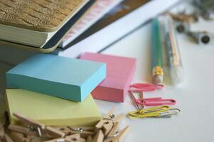 Small office supplies randomly lie on the desktop. photo