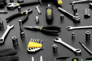 Many different tools for repair work on a black background. photo