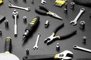 Many different tools for repair work on a black background. photo