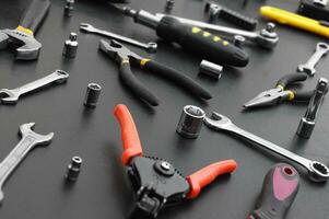 Many different tools for repair work on a black background. photo