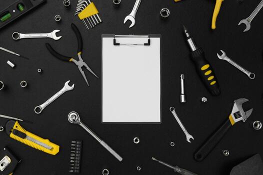 Notebook for writing, around various work tools on a black background. photo