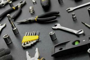 Many different tools for repair work on a black background. photo