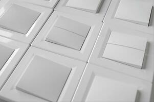 Many light switch, a plastic mechanical switch of white color. photo