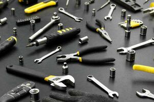 Many different tools for repair work on a black background. photo