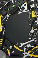 Many different tools for repair work on a black background with copy space for text. photo