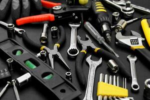 Many different tools for repair work on a black background. photo