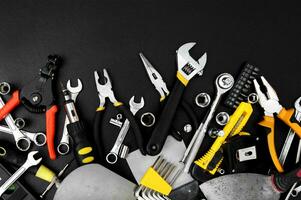 Many different tools for repair work on a black background. photo