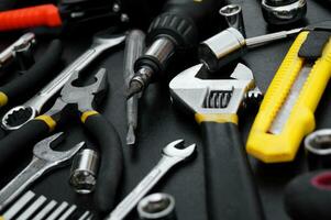 Many different tools for repair work on a black background. photo