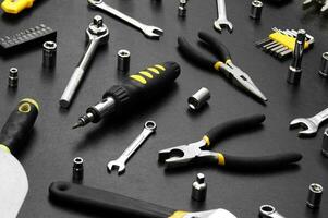 Many different tools for repair work on a black background. photo